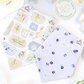 dog bandanas with patterns on a white surface with flowers.