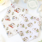 dog bandanas with cartoon designs on a white background with flowers.
